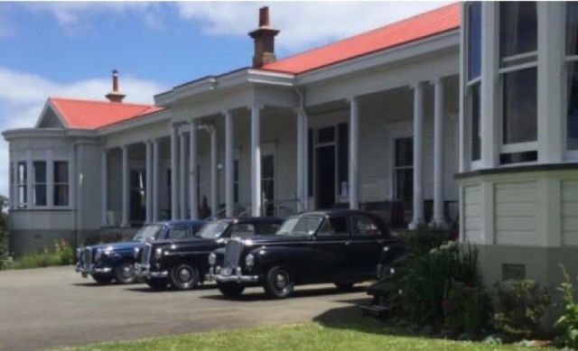 Cars in front of the homestead