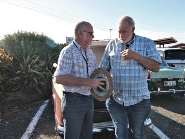 Derek Brehaut and Hugh Mackenzie discussing cork clutch plate from a 25HP super 6